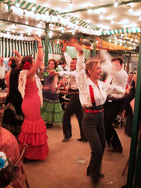 People in traditional Andalucian costumes, dancing the sevillana