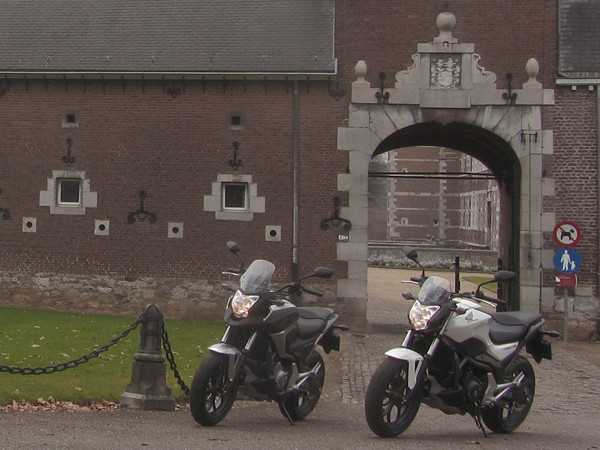 Two motorcycles in front of a castle