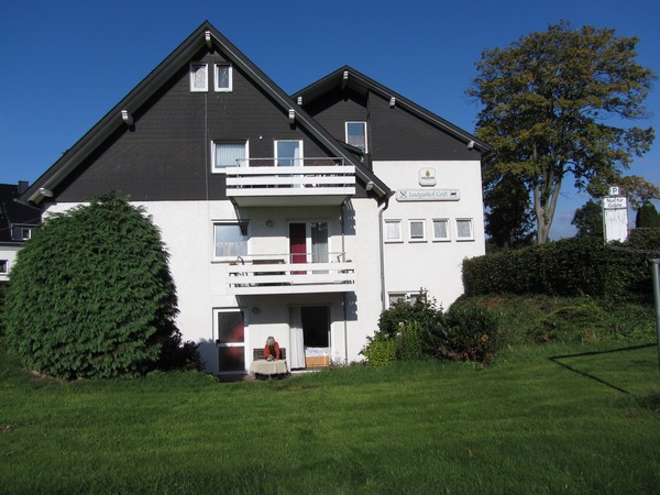 meadow, building with terrace, in the sun