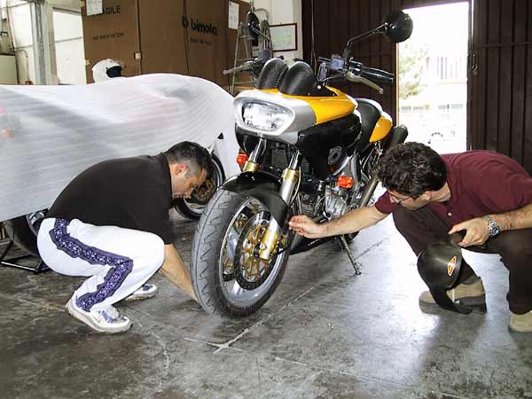 Two man kneeling with a Bimota Mantra