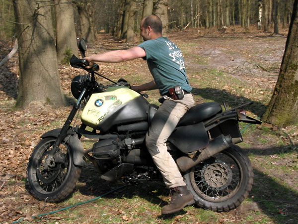 Riding a motorcycle without a helmet, in the woods