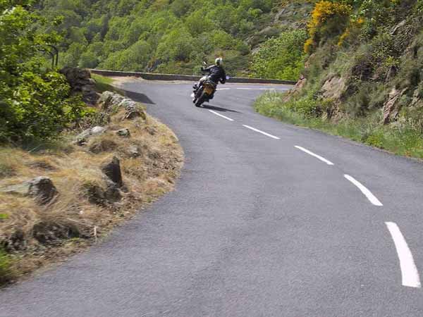 Motorcycle at the outside of a blind corner