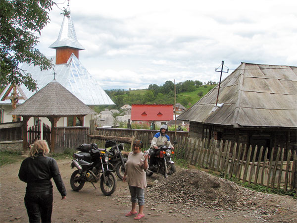 Muddy street, three motorcycles