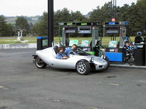 Three-wheeled sport vehicle at a gas station