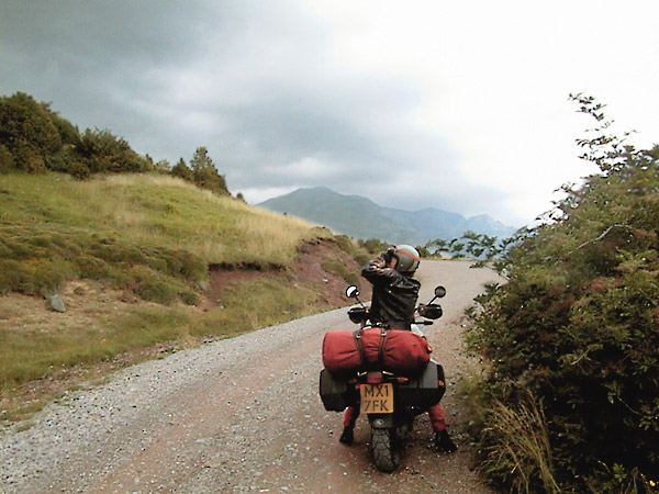 Sylvia on her BMW R1100GS, looking through binoculars (stopped)