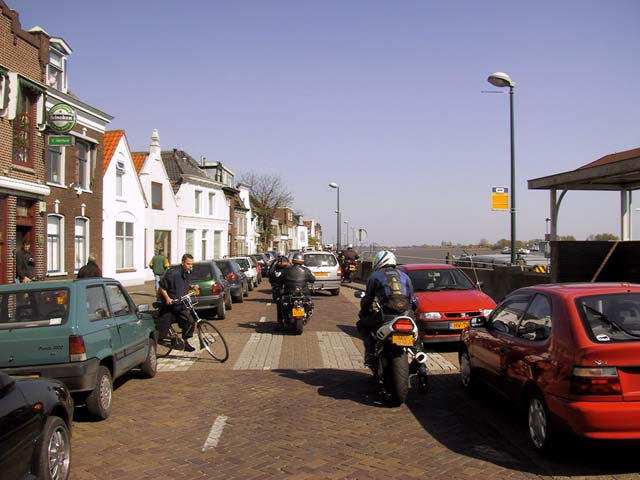 Bicycle rider trying to cross a street with motorcycle riders