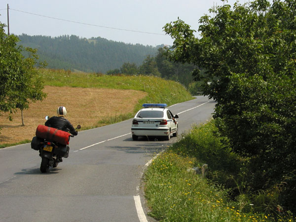 Motorcycle rider overtaking a police car