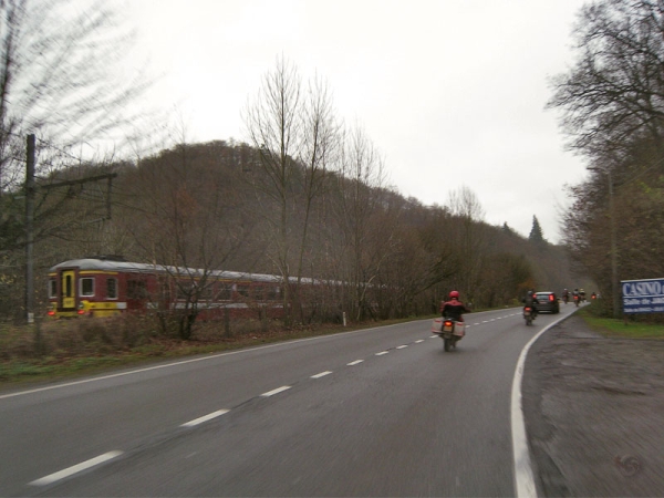 Two motorcycle riders behind a car