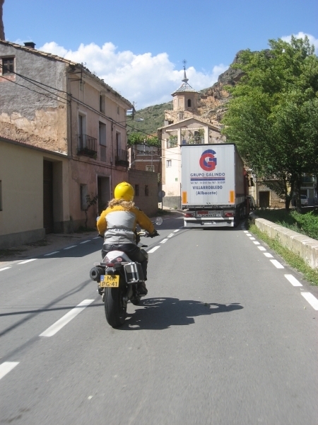 Motorcycle rider behind a truck