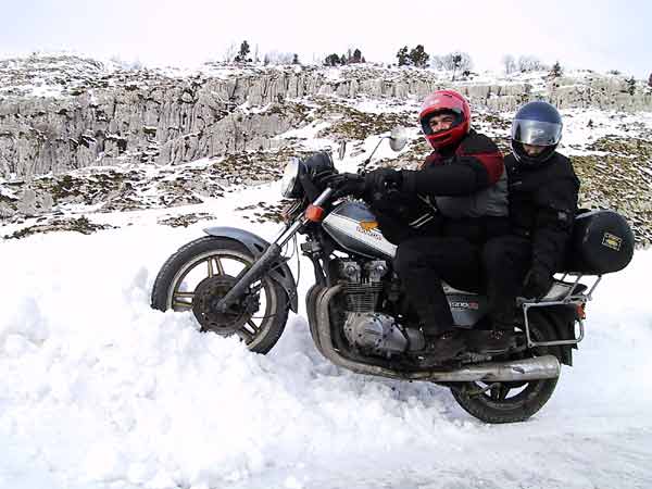 Motorcycle, with rider and pillion, stuck in the snow
